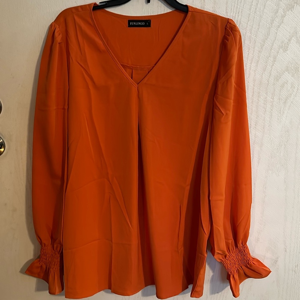 Women’s V-neck blouse. Size L. Long sleeve, banded, ruffle. Orange.